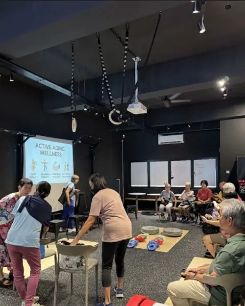 An Active Aging Wellness seminar in progress, with the session title on the screen behind the attendees.